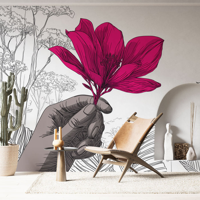 Fototapet exotiska blommor | En hand som håller en ljusrosa blomma mitt i stiliserad natur