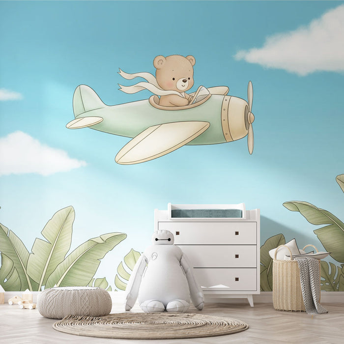 Fototapet pilot ayı | Tropikal yaprakların üzerinde uçakta gülümseyen bir ayı